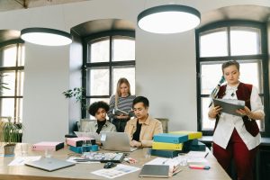 Startup founder and team planning content strategy on a laptop in a modern workspace.