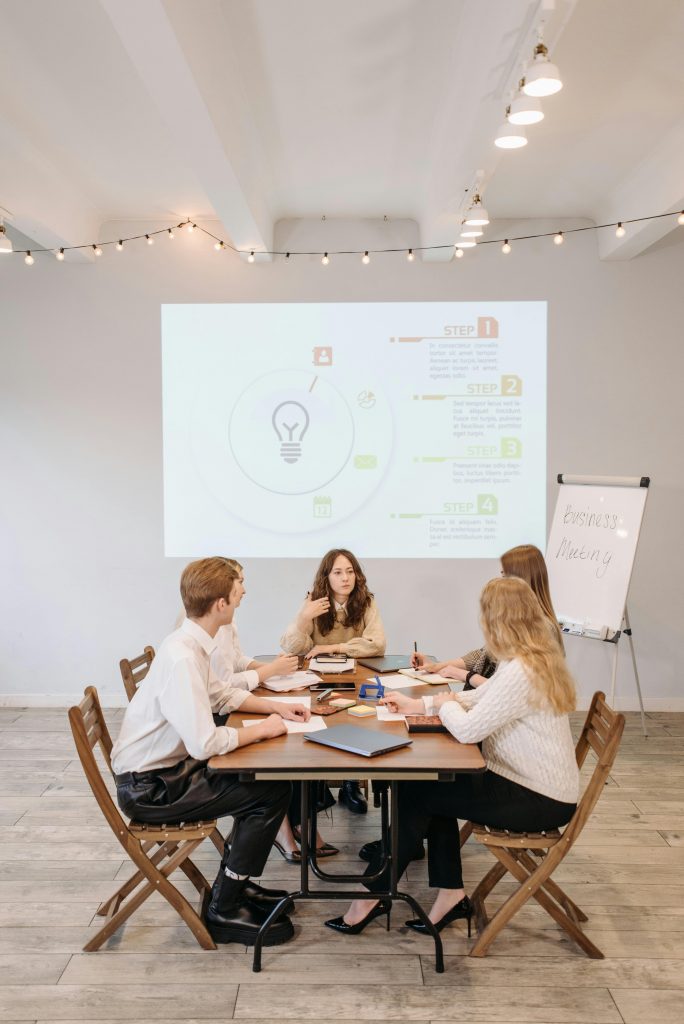 Startup team reviewing digital marketing dashboard with user growth chart on screen.