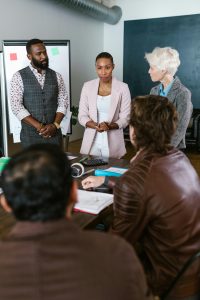 “Personal branding for startup founders – a young entrepreneur presenting to their team.”