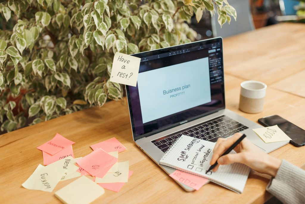 "Entrepreneur setting up digital systems for a lean digital-first business on multiple devices.