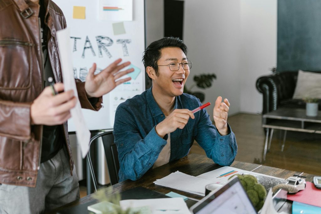 Business team planning SMART marketing goals on whiteboard